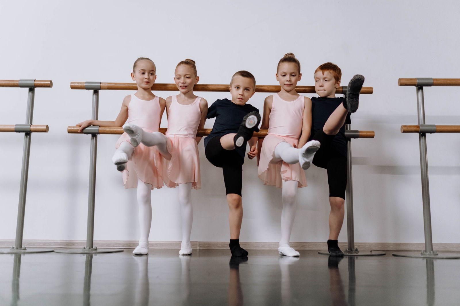 Dancers working at the barre in a studio