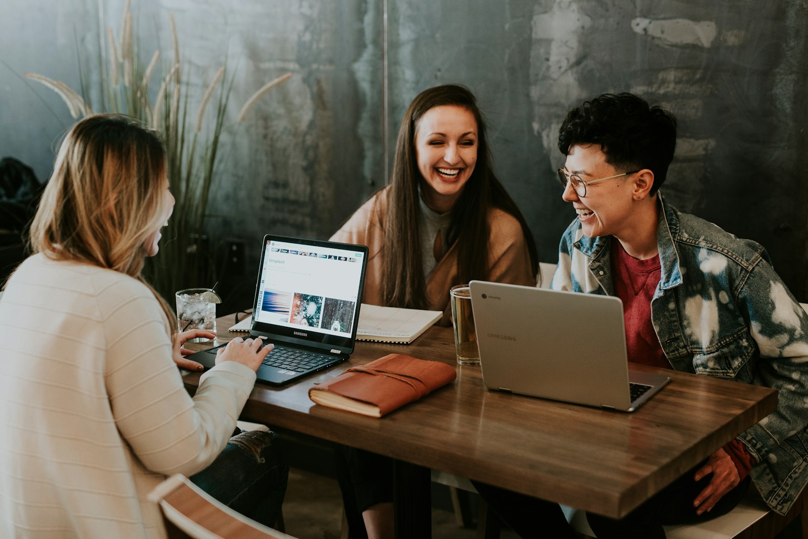 A parent booking a class on a laptop at a kitchen table